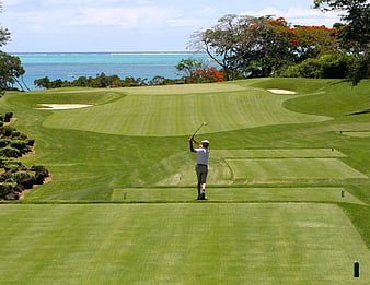 Golfer Teeing Off on Scenic Oceanfront Golf Course