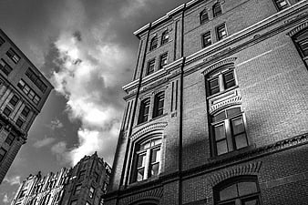 Low angle black and white view of historic brick architecture