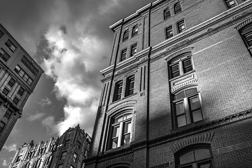 Low angle black and white view of historic brick architecture