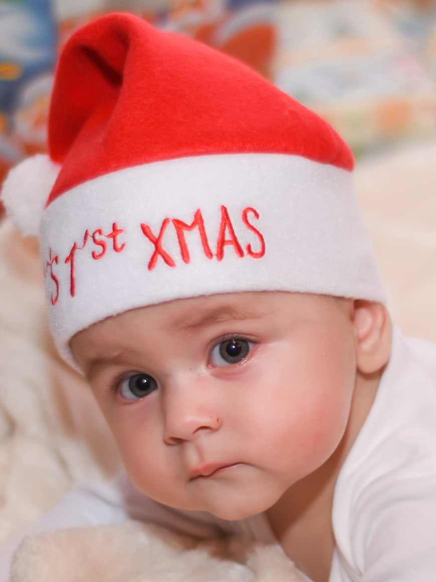 Adorable Baby Wearing First Christmas Santa Hat Close Up