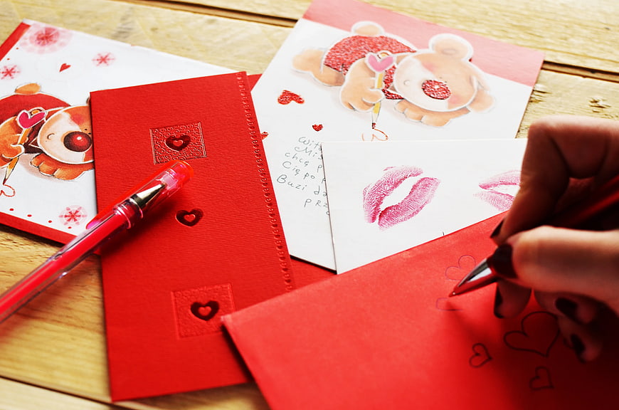Hand Writing Valentine's Day Card with Red Pen
