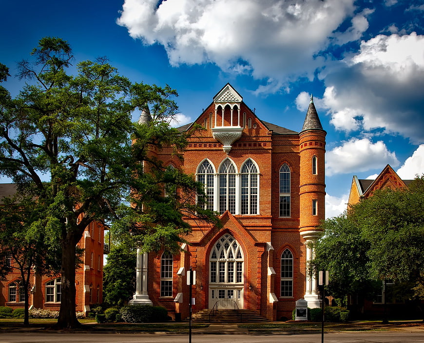 Red Brick Gothic Revival Building with Blue Sky