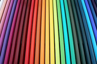 Rainbow colored pencils arranged in a vibrant spectrum