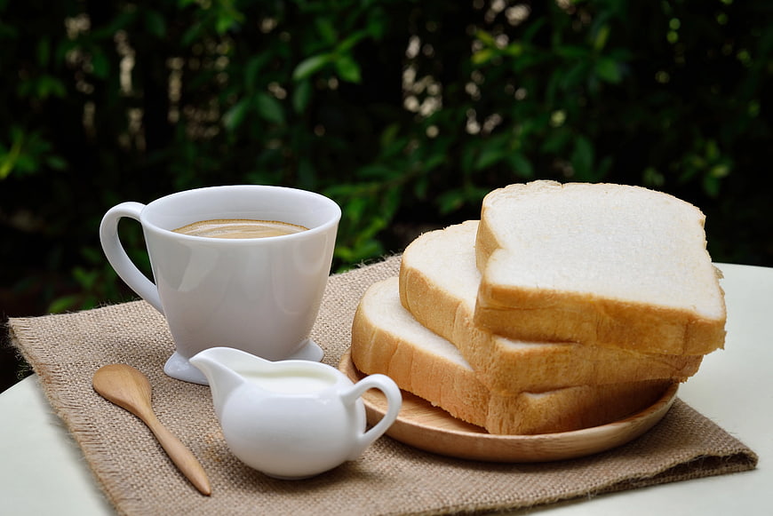 Sliced White Bread and Coffee Cup on Burlap Placemat