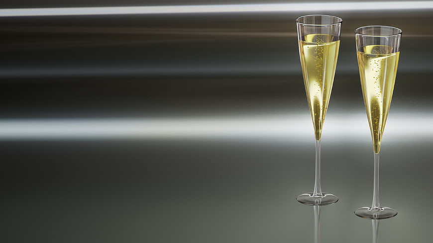 Two champagne flutes with sparkling wine on a sleek background