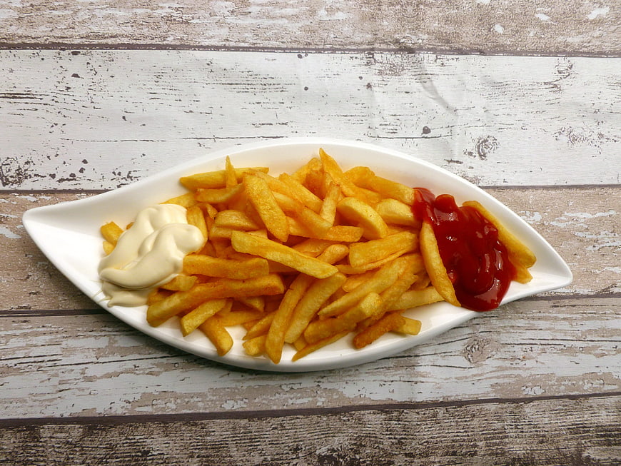 Golden French Fries with Ketchup and Mayonnaise on White Plate