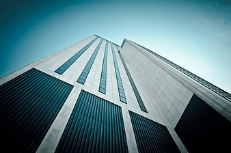 Low angle view of modern skyscraper architecture against blue sky