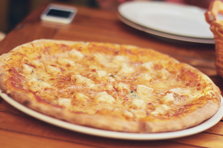 Delicious Chicken and Cheese Pizza on Wooden Table