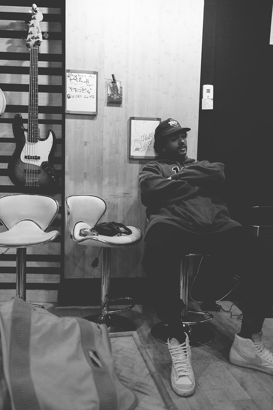 Man Relaxing in Music Studio with Bass Guitar