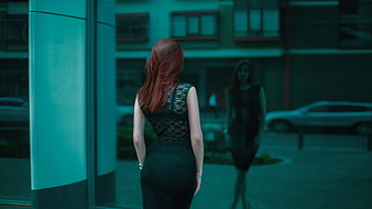 Woman in Black Lace Dress Looking at Reflection in Glass