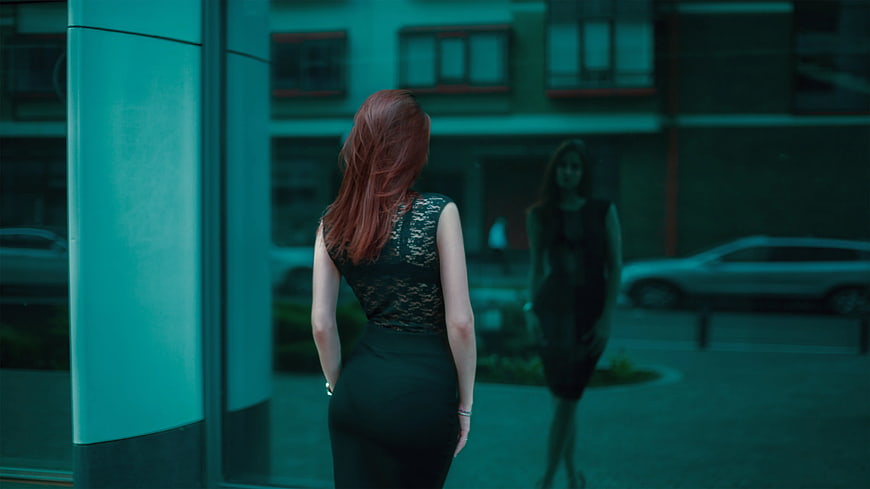 Woman in Black Lace Dress Looking at Reflection in Glass