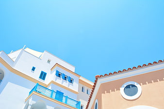 White and Peach Mediterranean Architecture Against Blue Sky