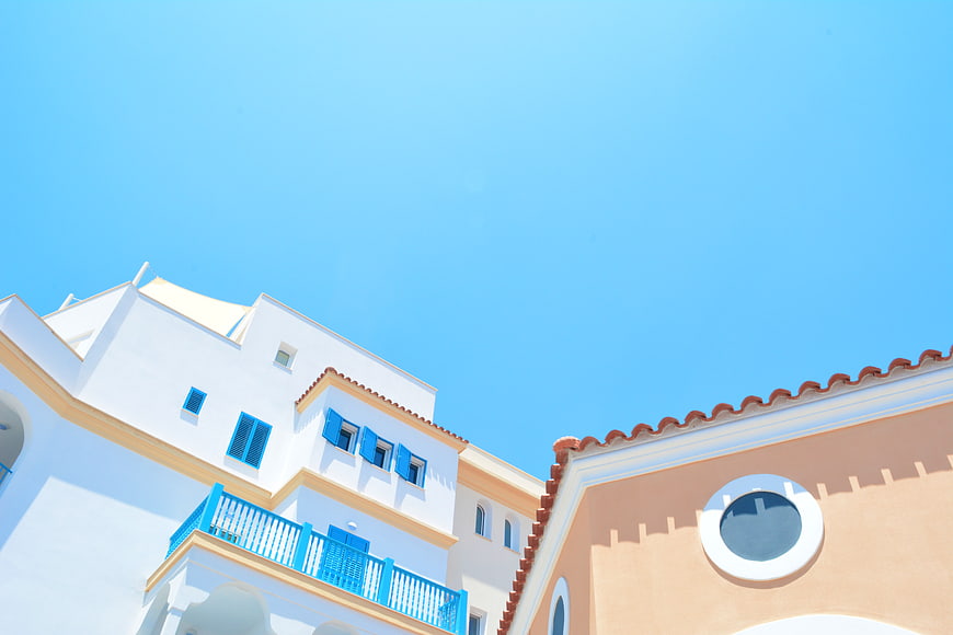 White and Peach Mediterranean Architecture Against Blue Sky
