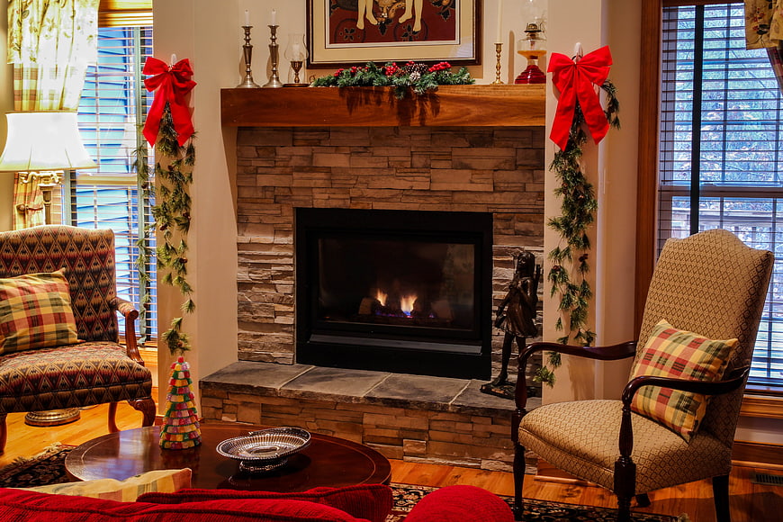 Cozy Living Room with Stone Fireplace and Christmas Decorations