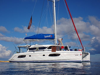 White Catamaran Sailboat Anchored in Blue Ocean