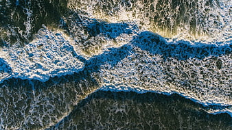 Aerial View of Ocean Waves Crashing on Shore