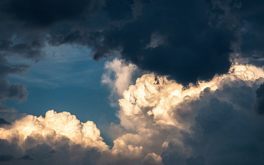Dramatic golden hour clouds against dark stormy sky