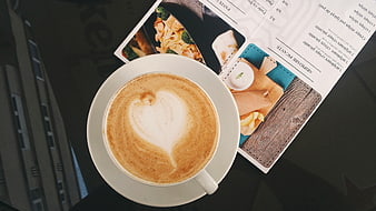 Top View of Cappuccino with Heart Latte Art and Magazine