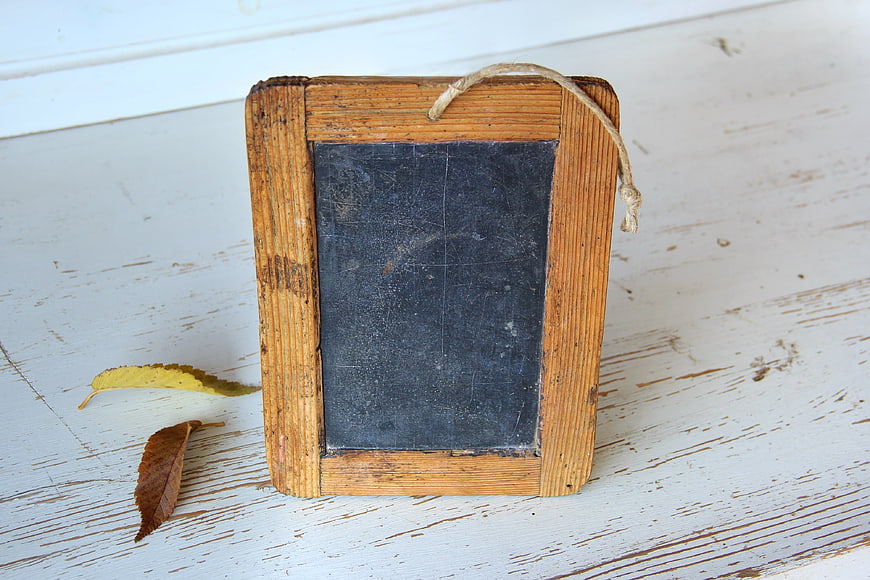 Vintage Wooden Chalkboard Frame With Autumn Leaves On Rustic White Wood