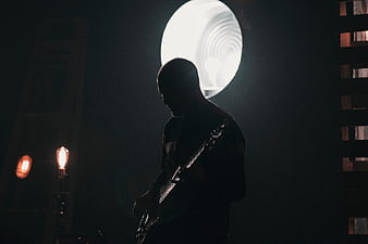 Silhouette of Guitarist Playing in Dark Studio with Backlight