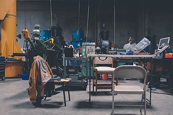 Industrial workshop interior with machinery and leather jacket