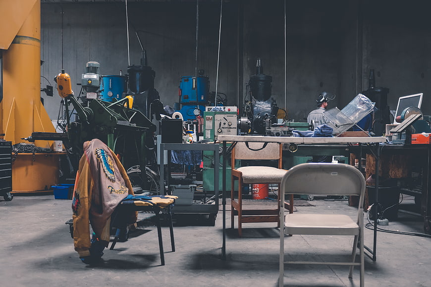 Industrial workshop interior with machinery and leather jacket