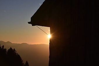 Sunset Silhouette of Mountain Cabin in the Alps
