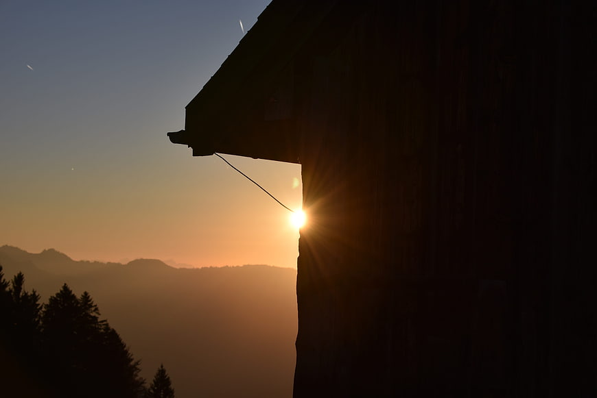 Sunset Silhouette of Mountain Cabin in the Alps