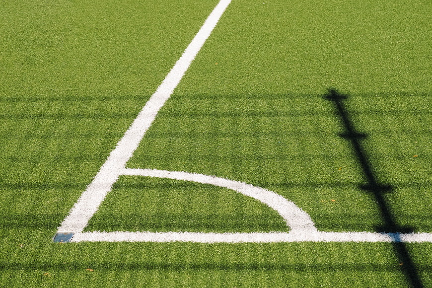 Soccer Field Corner Arc and White Lines on Green Grass