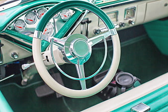 Vintage turquoise car interior with chrome steering wheel