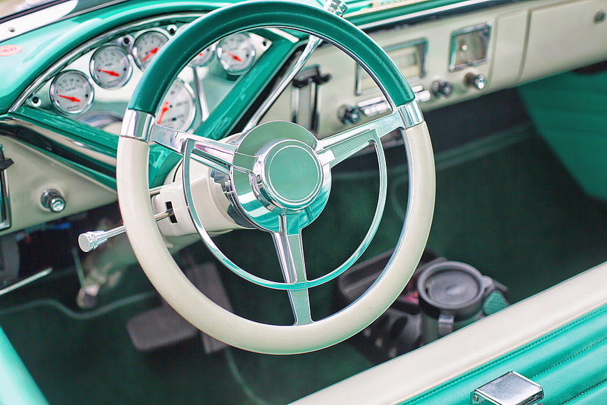 Vintage turquoise car interior with chrome steering wheel