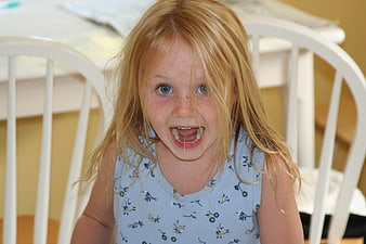 Candid Portrait of a Frustrated Young Girl with Freckles