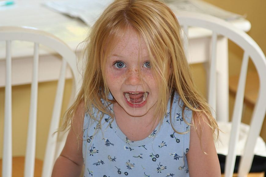 Candid Portrait of a Frustrated Young Girl with Freckles