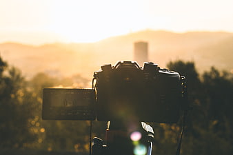 DSLR Camera on Tripod Filming Sunset Cityscape