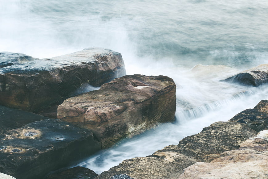 Long Exposure Ocean Waves Crashing on Rocky Coastline