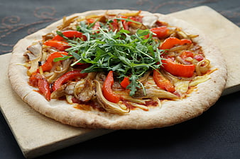 Vegan Pizza with Mushrooms, Peppers, and Arugula on Wooden Board