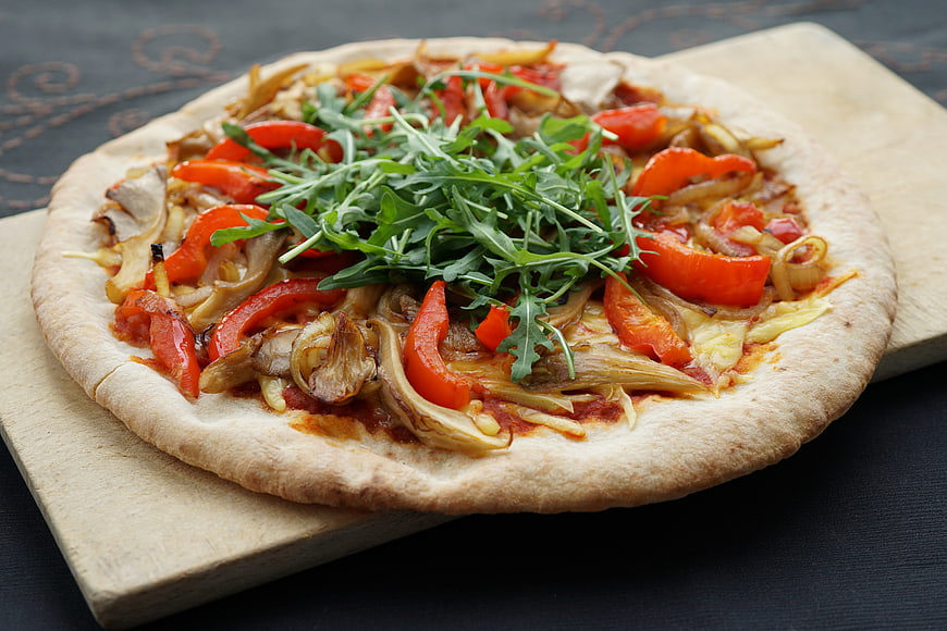 Vegan Pizza with Mushrooms, Peppers, and Arugula on Wooden Board
