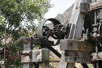 Vintage Gold Mining Machinery with Wooden Beams and Metal Gears