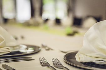 Elegant Table Setting with Silverware and White Napkins