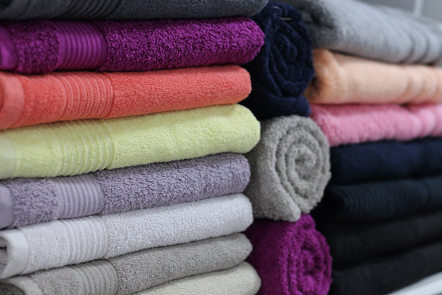 Colorful Stack Of Folded Bath Towels And Rolled Linens