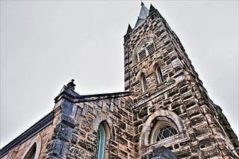 Low angle view of historic stone church tower architecture