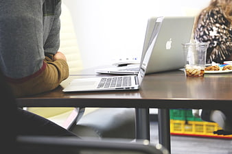 People working on laptops at a modern office table