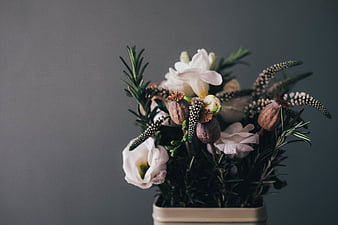 Elegant White Flower Arrangement In Small Vase Against Gray Background