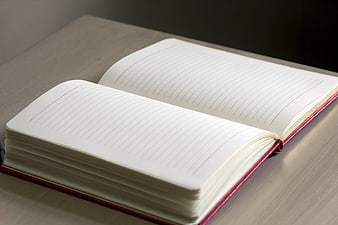 Open Lined Notebook on Wooden Desk Surface