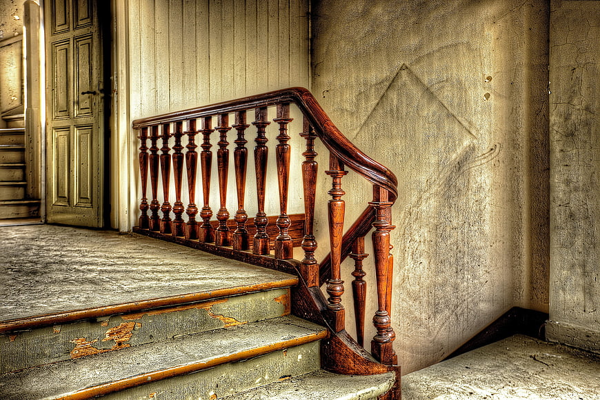 Vintage wooden staircase in abandoned house interior