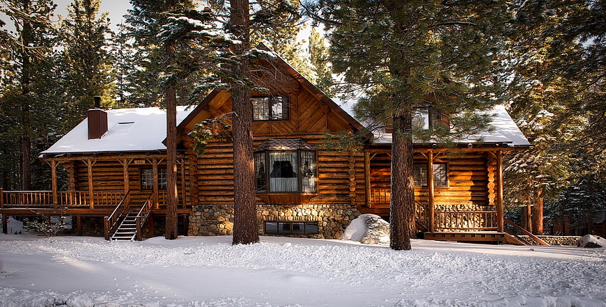 Rustic Log Cabin in Snowy Pine Forest Winter Landscape