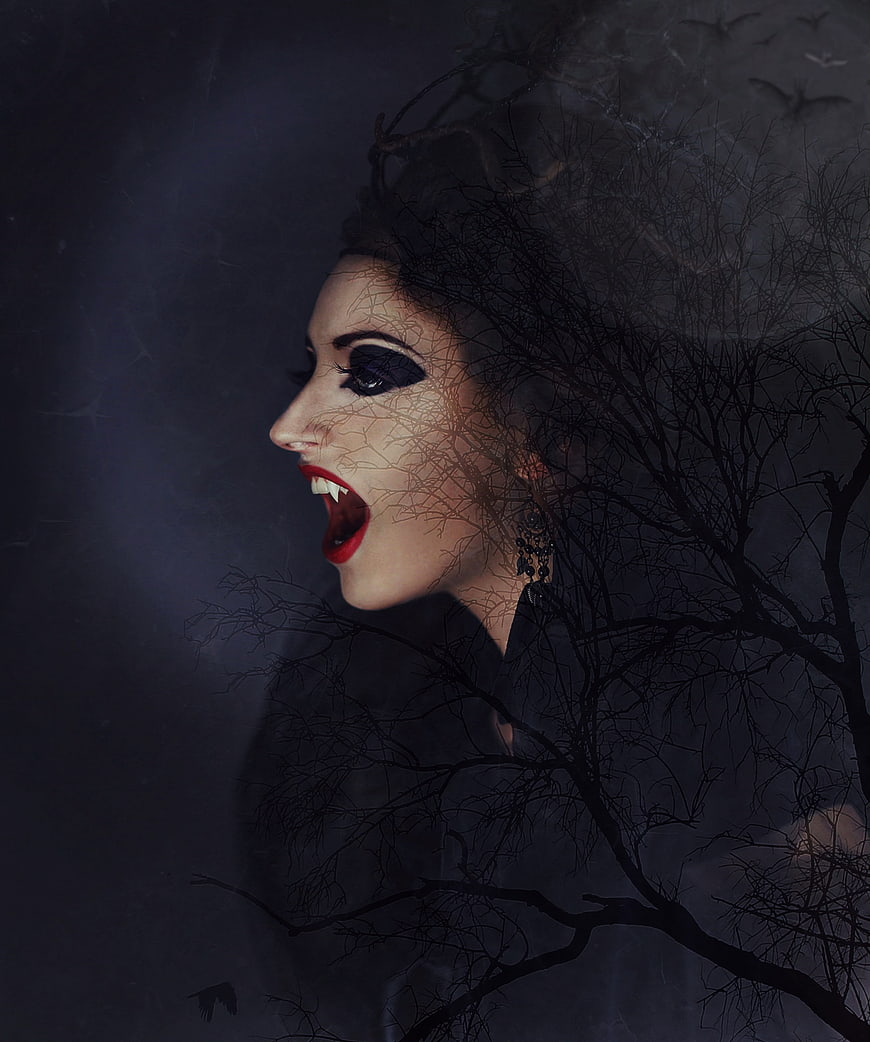 Dark fantasy vampire woman with tree branches and bats