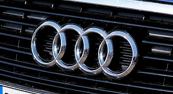 Close-up of Audi four rings logo on car grille