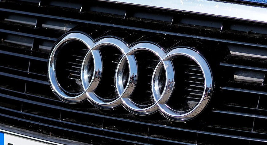 Close-up of Audi four rings logo on car grille
