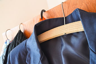 Close-up of Navy Blue Blazer on Wooden Hanger